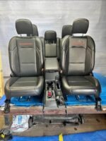 set of black leather seats with red stitching and "RUBICON" embroidered in red, which are the front and rear seats