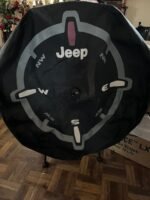 Mopar Genuine Jeep Wrangler spare tire cover with a compass design.