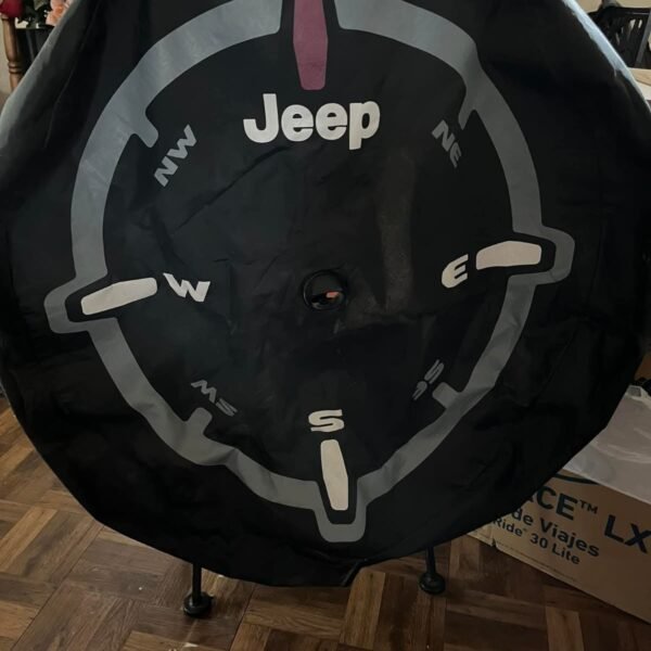 Mopar Genuine Jeep Wrangler spare tire cover with a compass design.